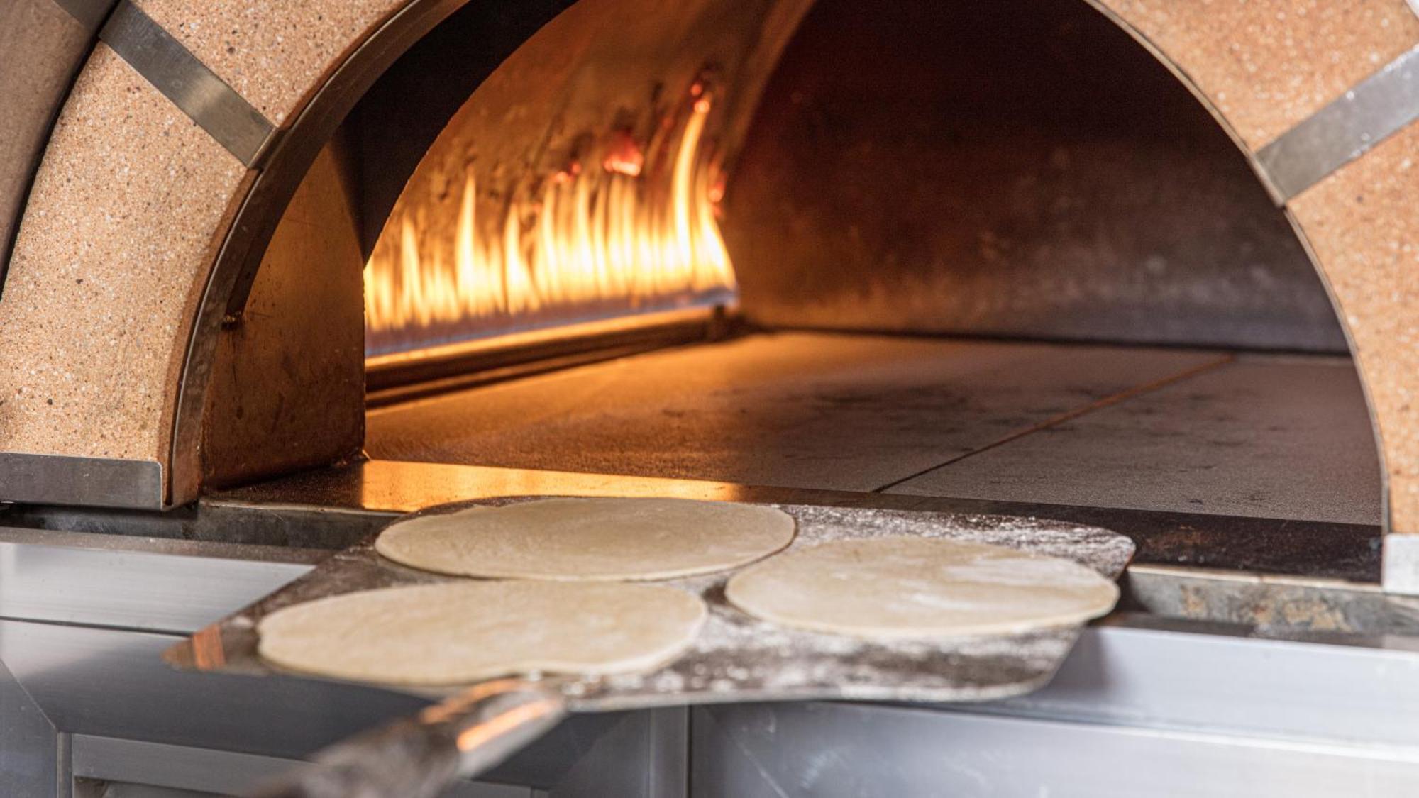 The Abdali Boulevard Hotel Amman Zewnętrze zdjęcie Pizza dough in a wood-fired oven